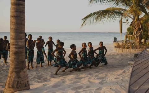 locals in mozambique dancing on the beach
